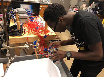 A student works with wires in a lab