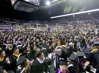 A student celebrates receiving their diploma.