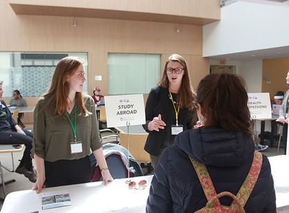 Holy Cross students talk to a high school student about the study abroad program.
