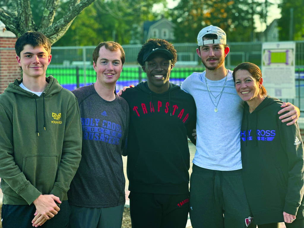 Four young men and a middle aged women smiling