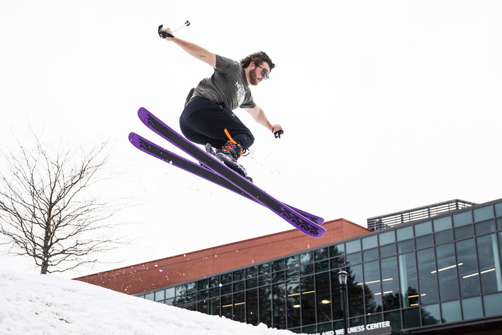 a skier gets air off a small jump
