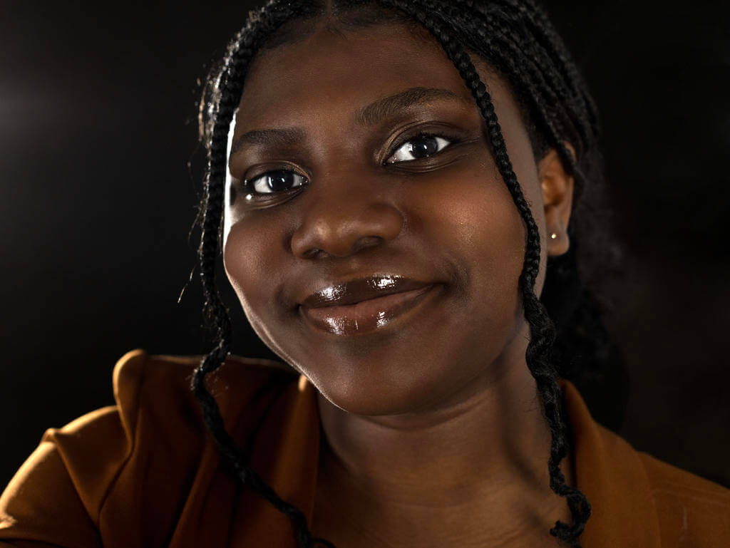 A woman smiling looking straight ahead