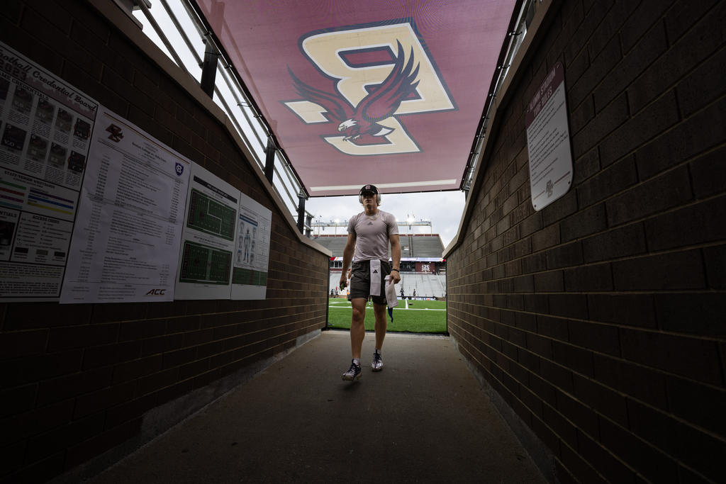 Football player in uniform enters a tunnel