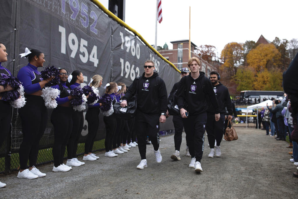 Men walk in black sweatsuits
