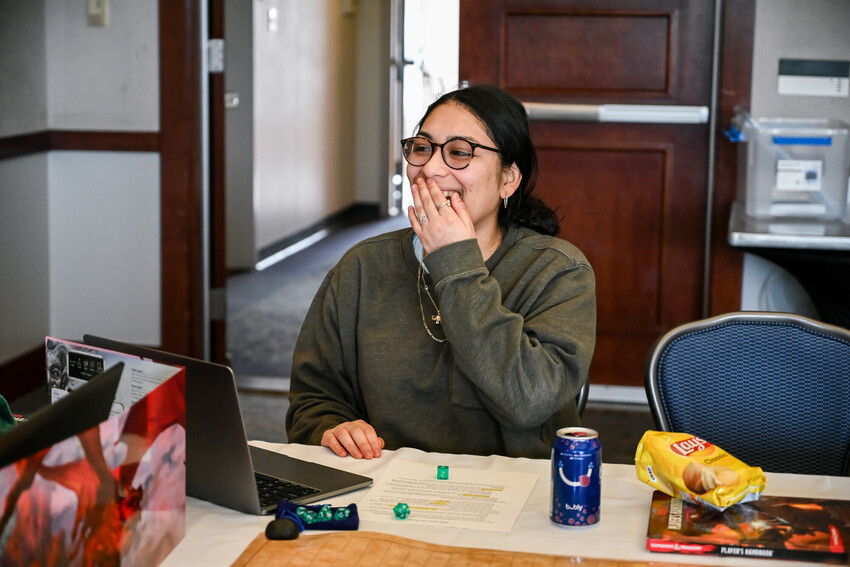 Woman laughs and covers her mouth