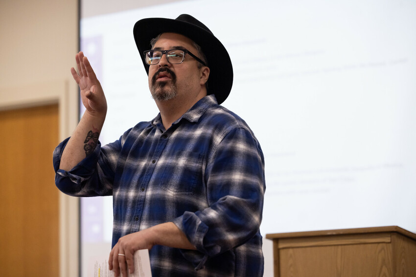 Man in cowboy hat addresses a class