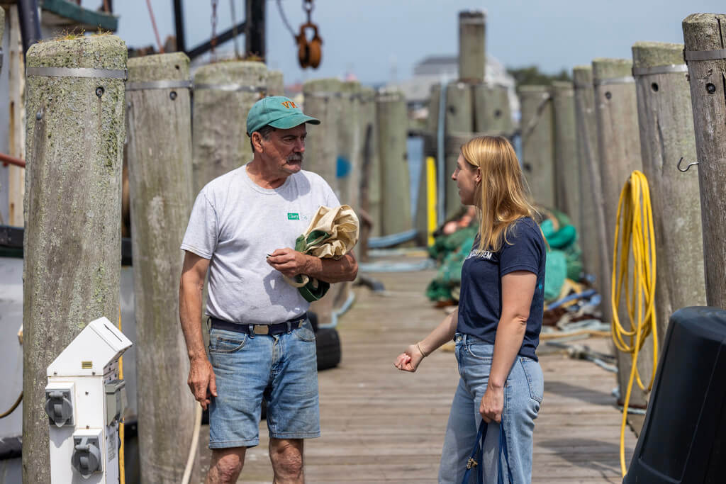 Man and man talk on a dock