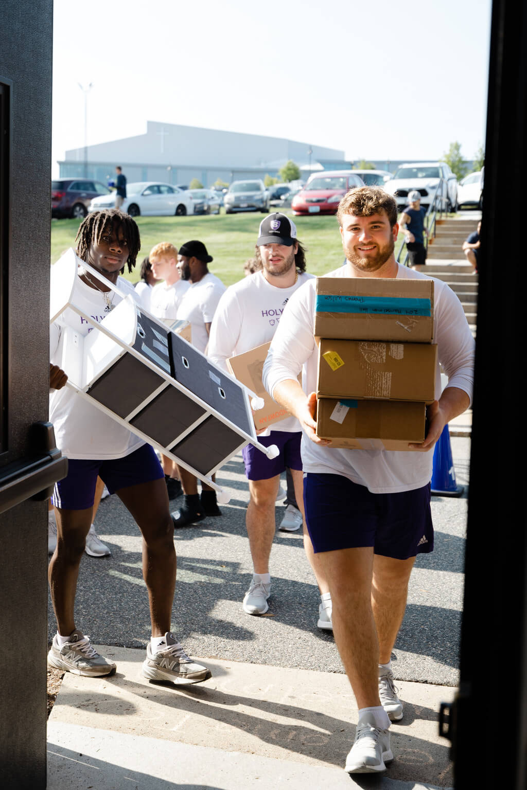 Four men carrying boxes