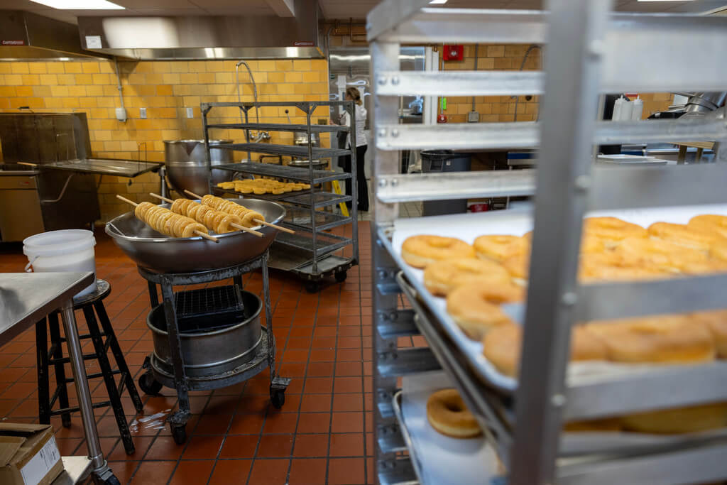 After drying for approximately 20 minutes the glaze is set and the donuts are ready to be placed on trays and served.