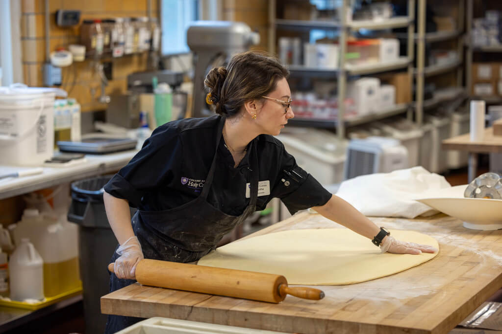 Woman rolls out dough