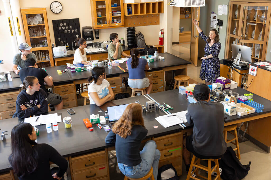 Woman teaches class full of students
