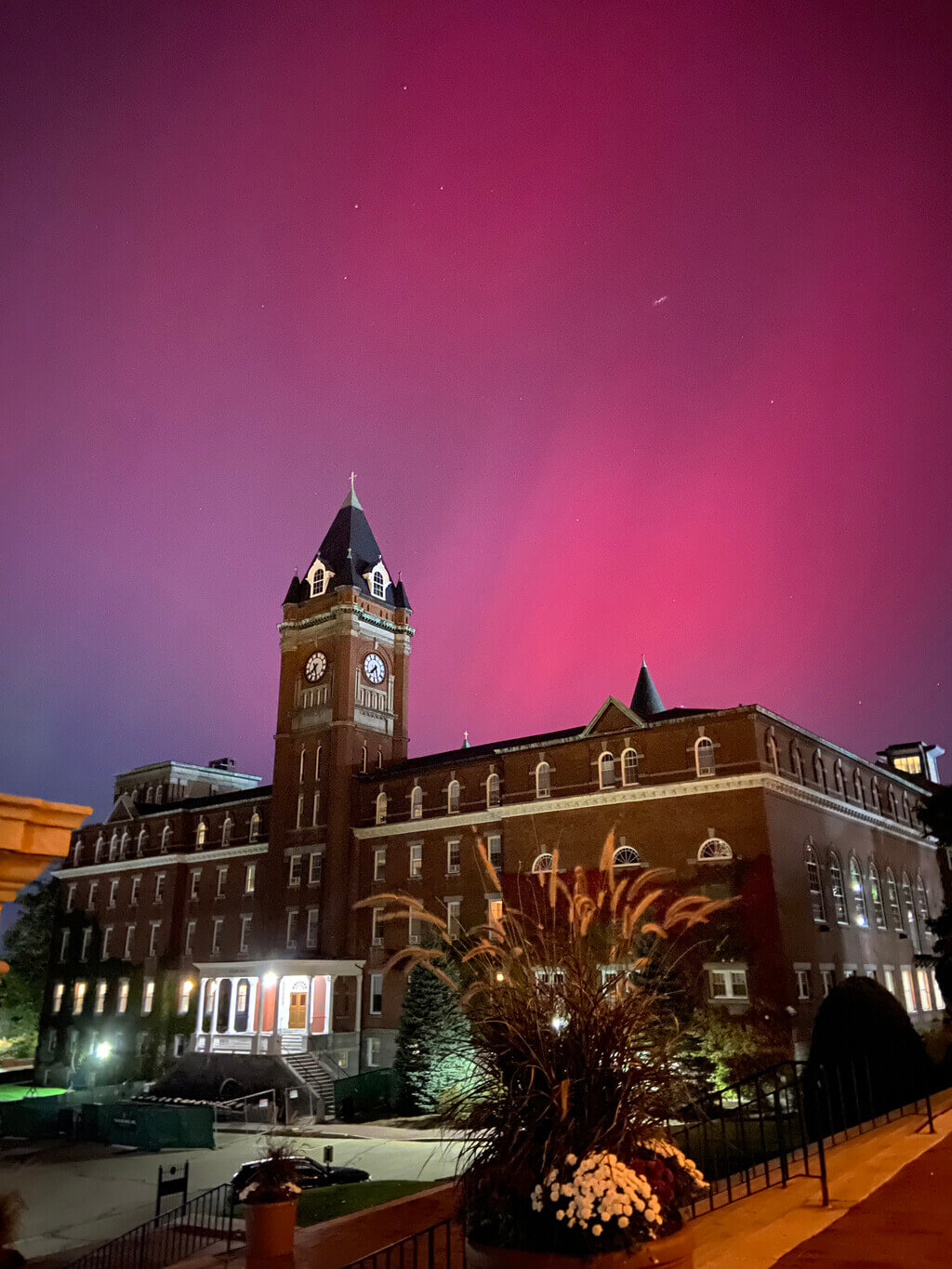 Northern lights over a brick building