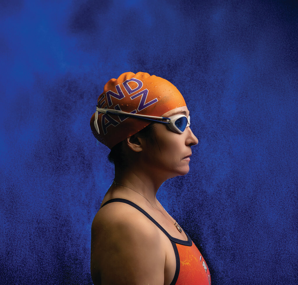 Woman in swimcap, goggles and swimsuit