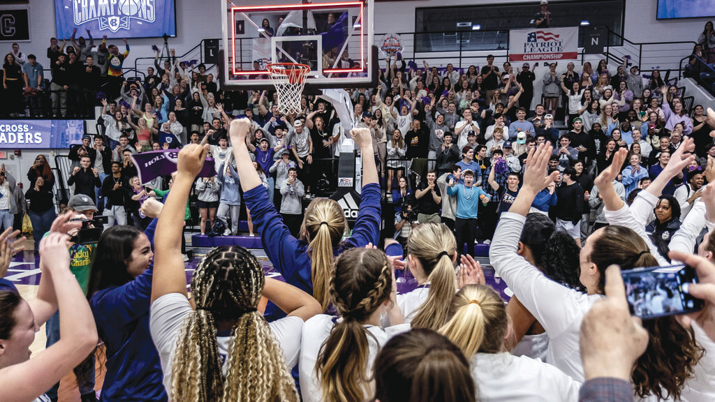 Women baskeball players celebrate on a court