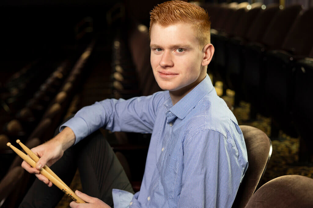 Portrait of man holding drumsticks