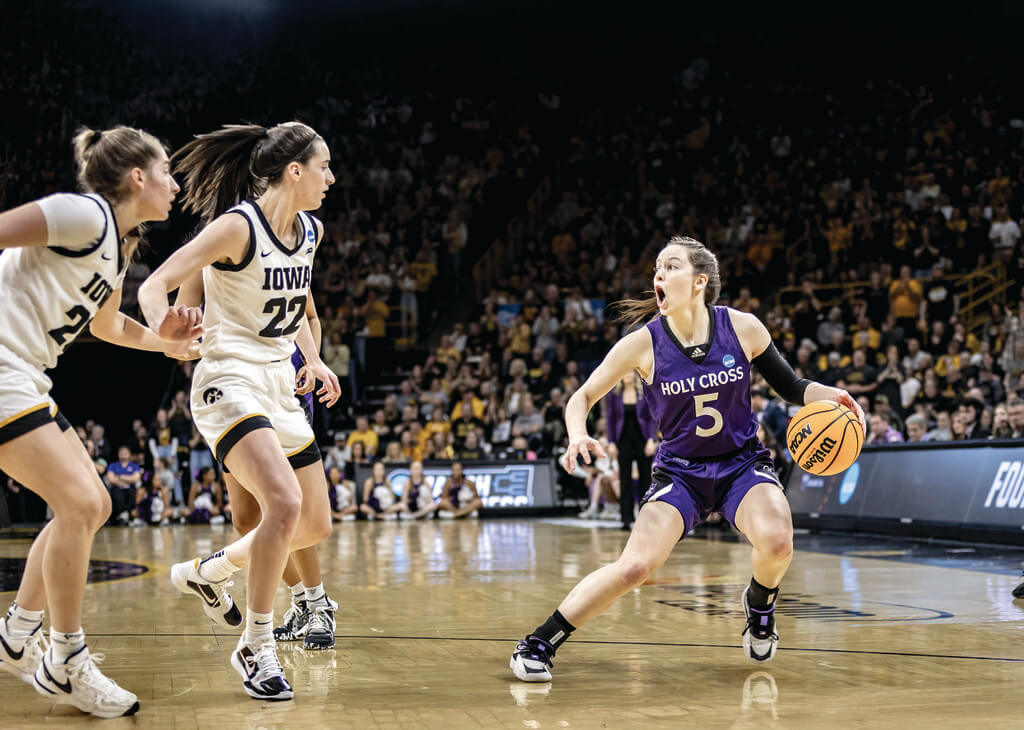 Woman basketball player dribbles against opponent