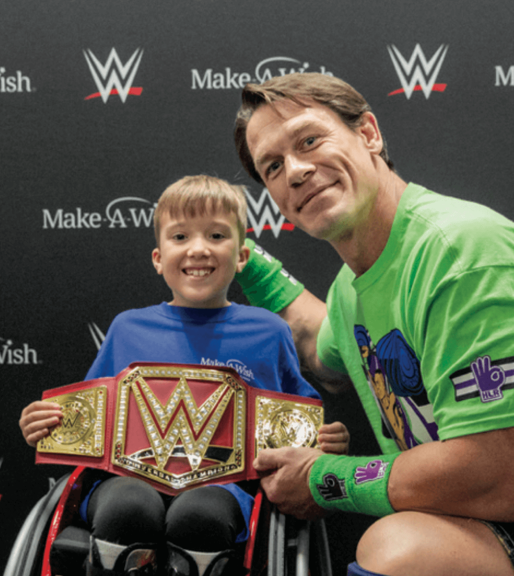 man sits nect to child holding a championship belt