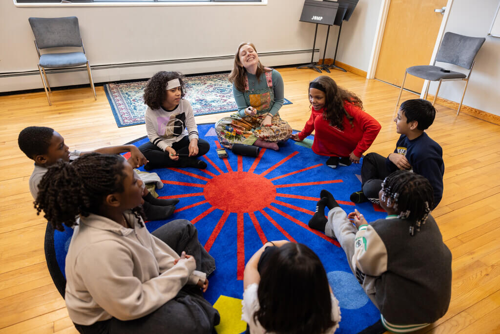 Students sitting in a circle on the floor