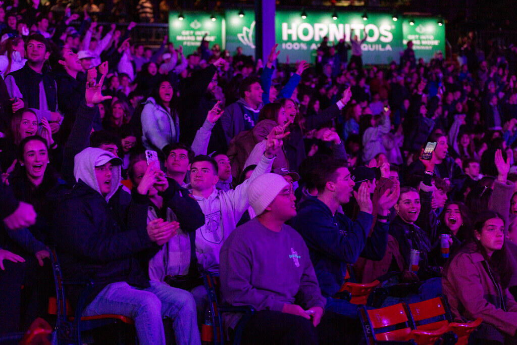 Fans cheering under purple lights