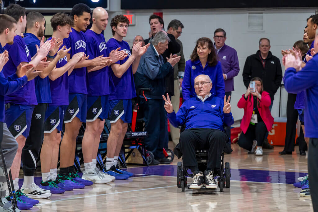 Man in wheelchair and basketball team