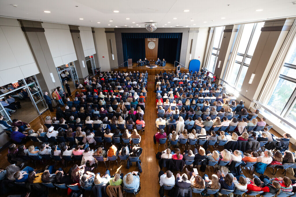 Aerial shot of a crowd of people sitting in chairs