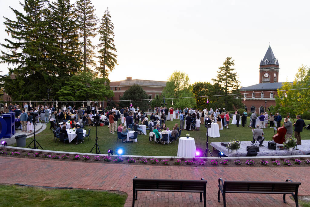 People sitting at tables on the lawn