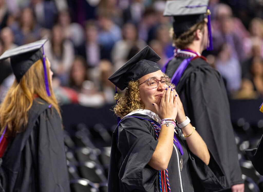 Graduate looks at the crowd