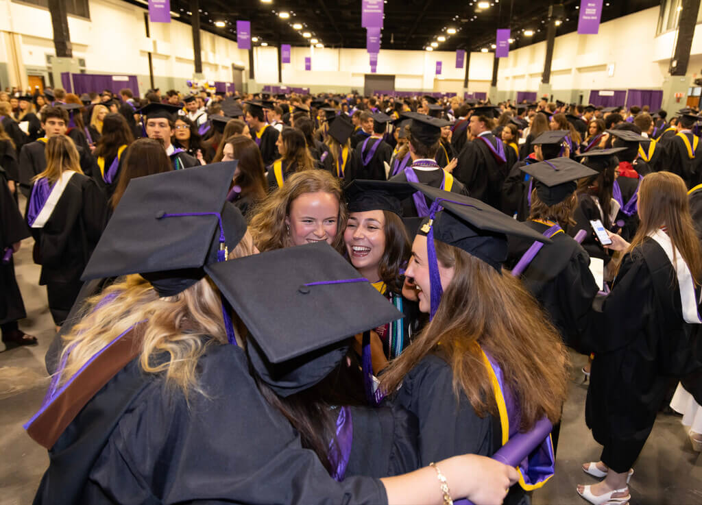 A group of graduates hugging