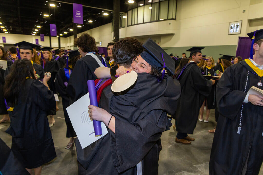 Two graduates hugging