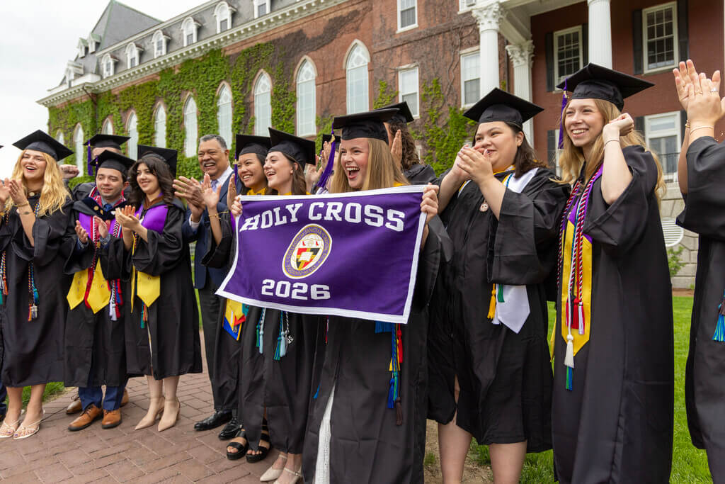 Cheering graduates with a Class of 2026 banner