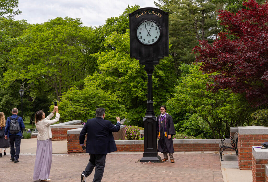 Student posing by clock tower