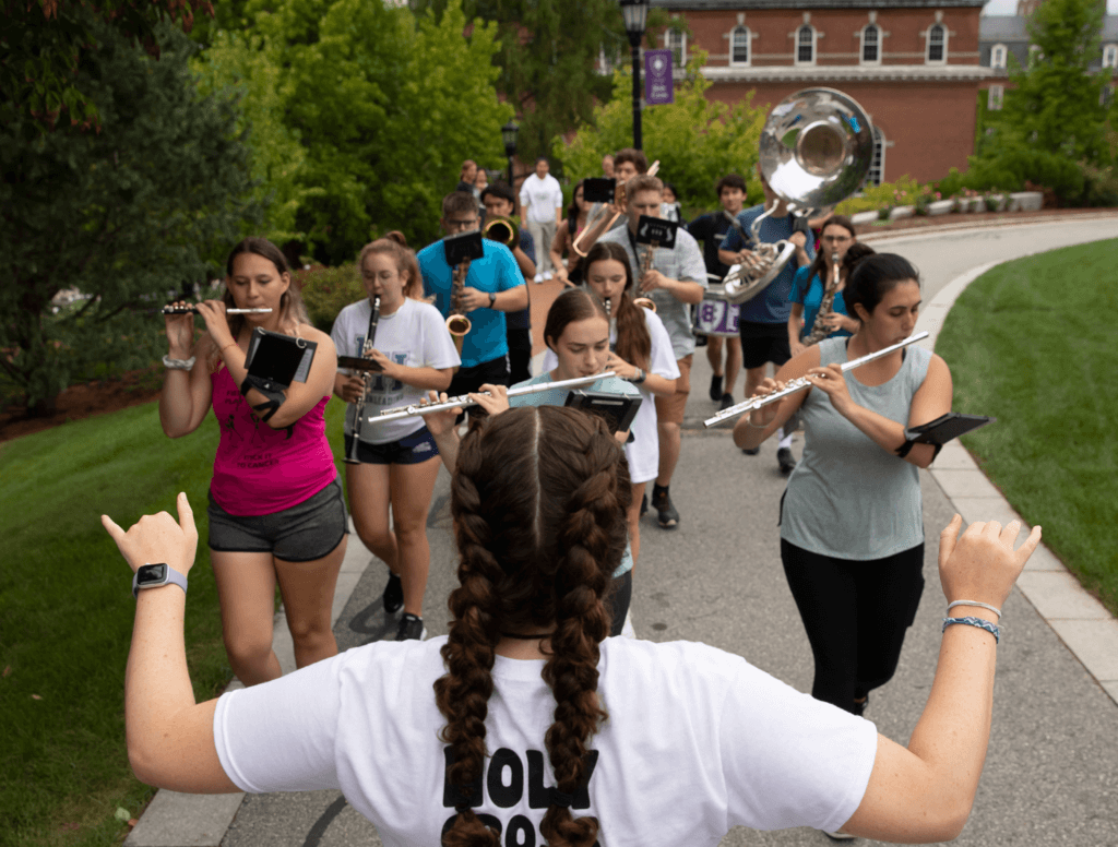 Student conducts band members outside on the Hoval