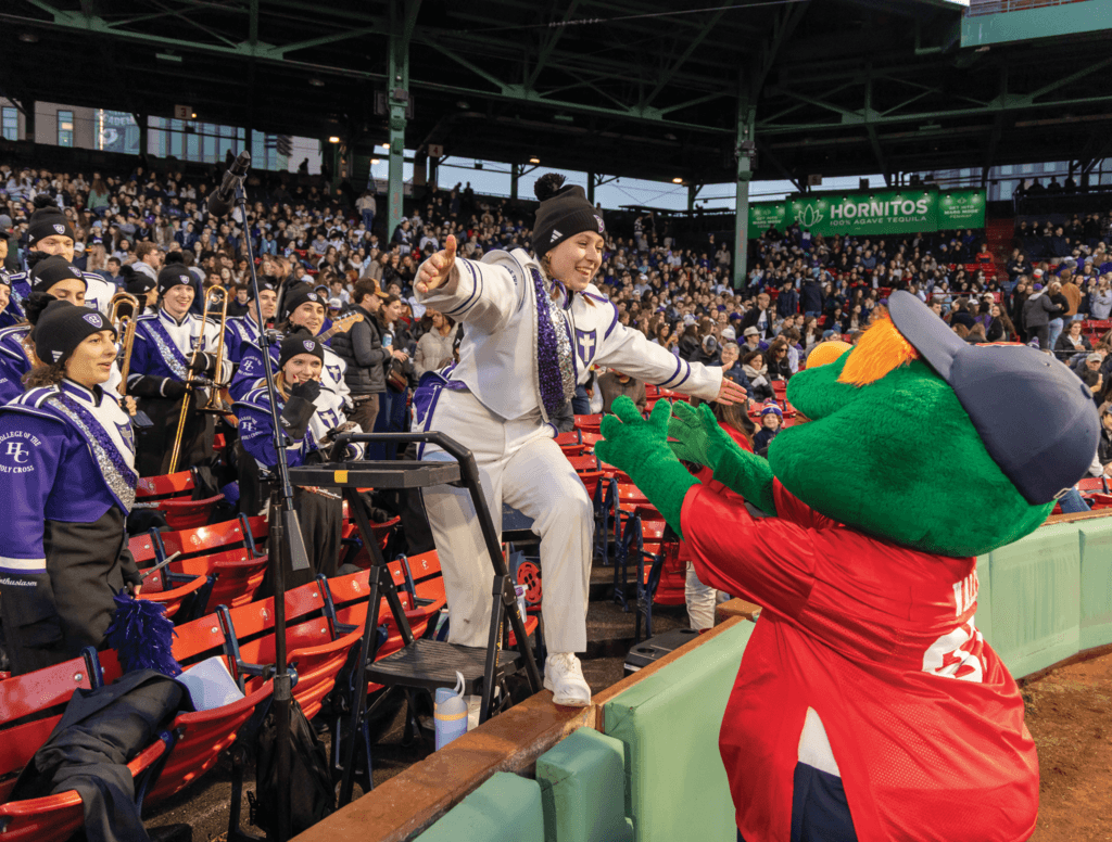 Young woman goes to hug team mascot