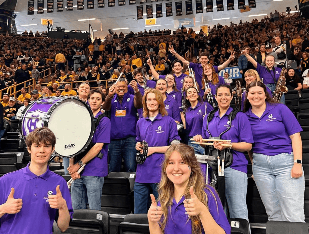 Pep band and President Rougeau in the stands Iowa