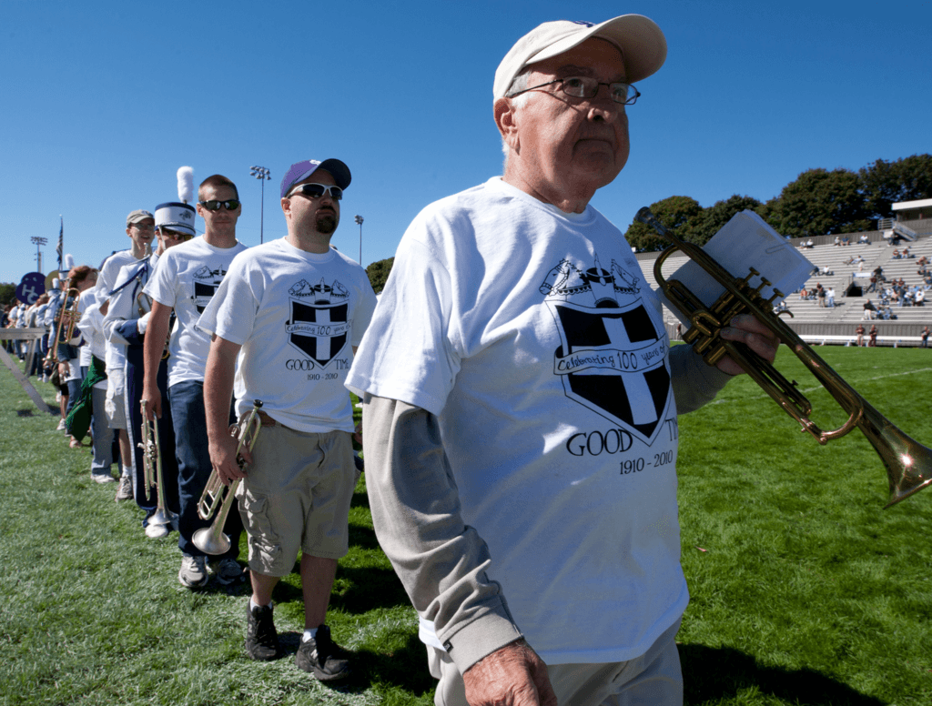 Band alumni lined up on football field