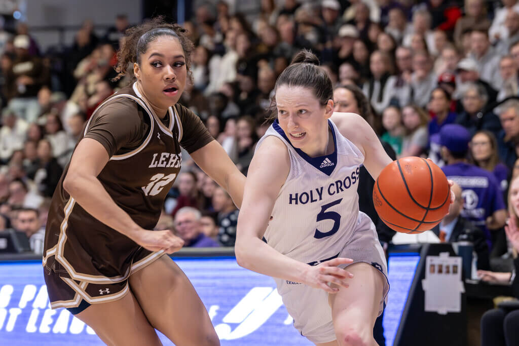 Kaitlyn Flanagan dribbling a basketball against opponent