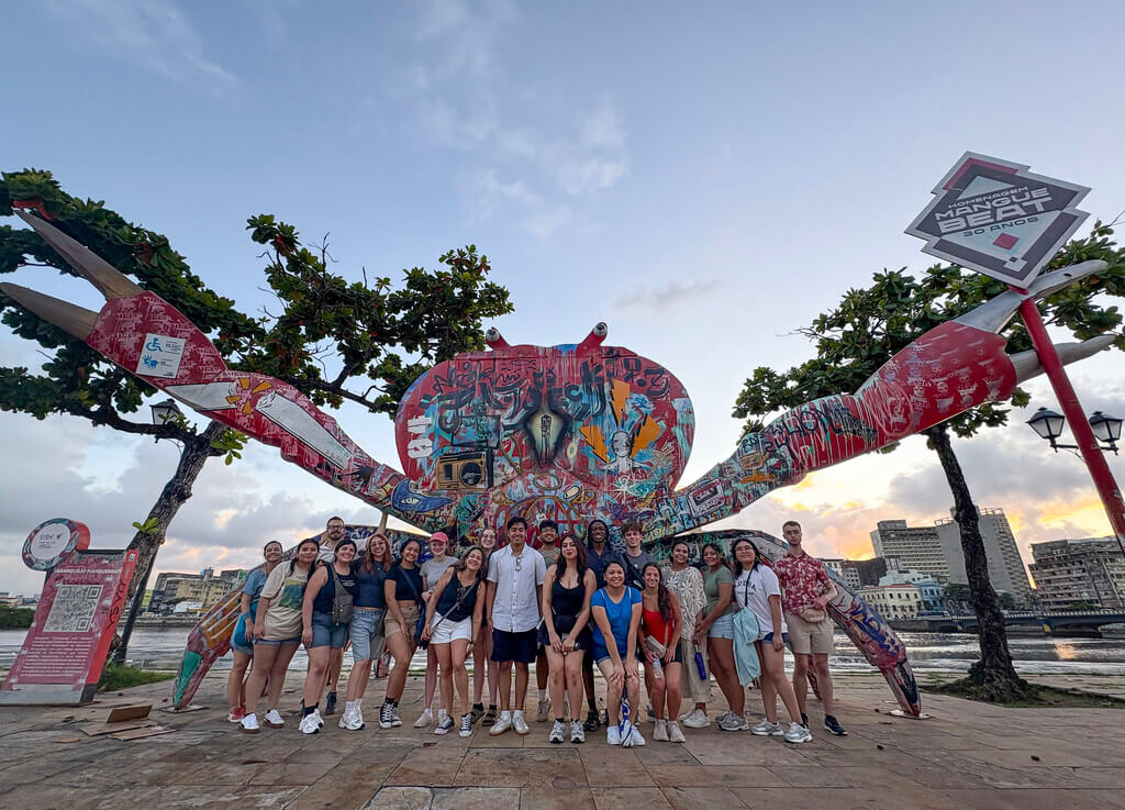 Group of people in front of a crab statue
