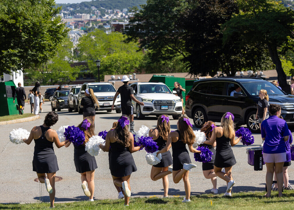 Cheer team greets cars