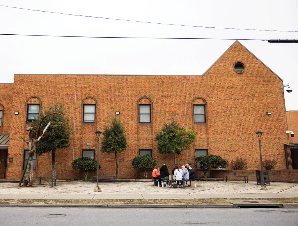 Students sitting in front of a building