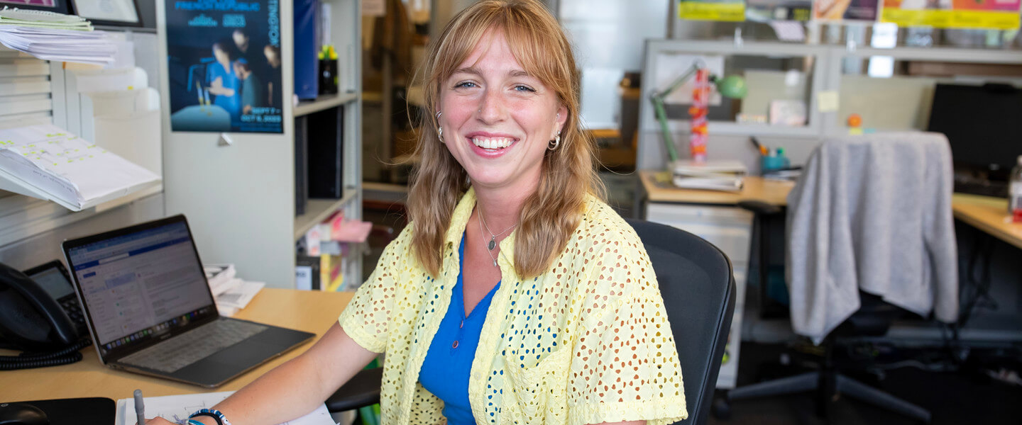 Woman sits at desk