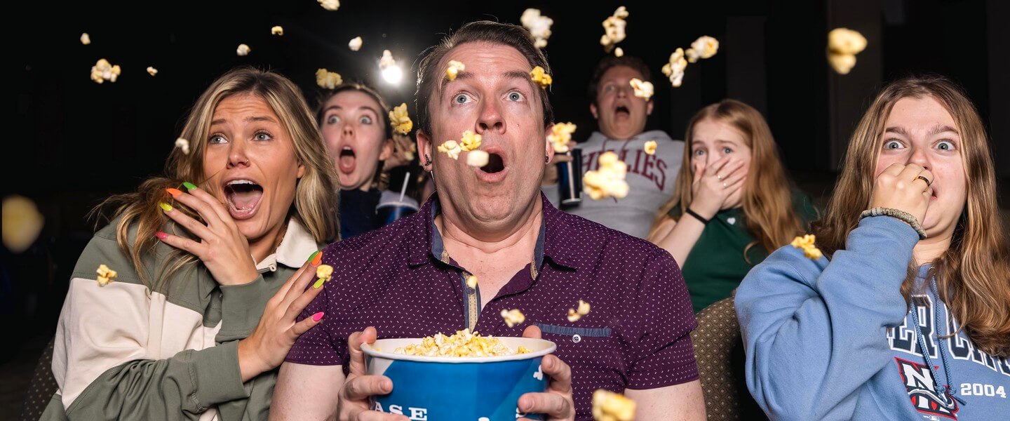 People with popcorn in movie theater