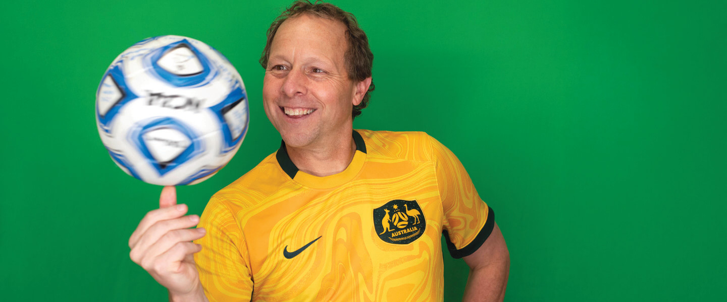 Man spins soccer ball on hand