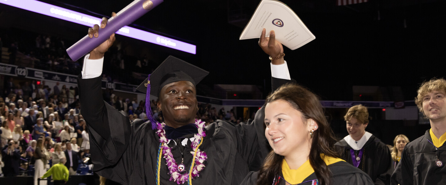 Students in procession celebrating their college graduation