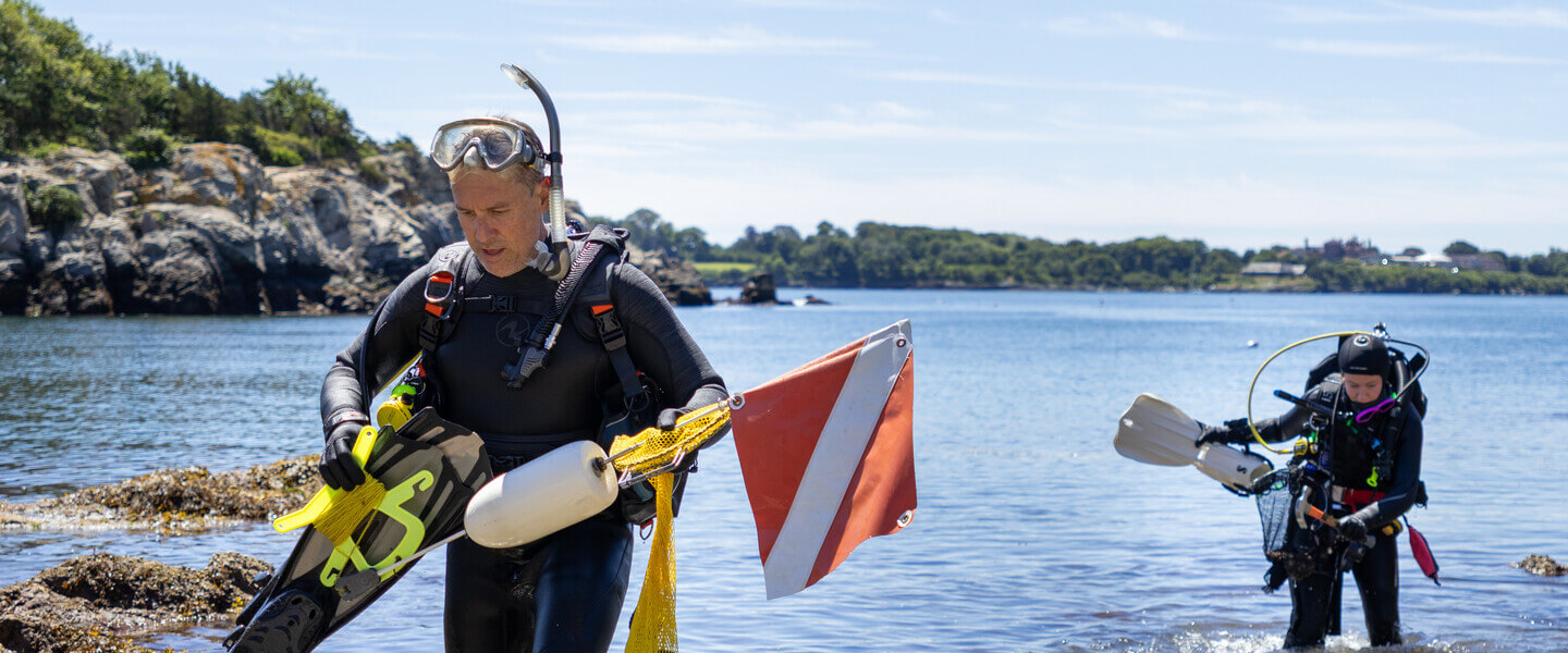 Two scuba divers returning from the water