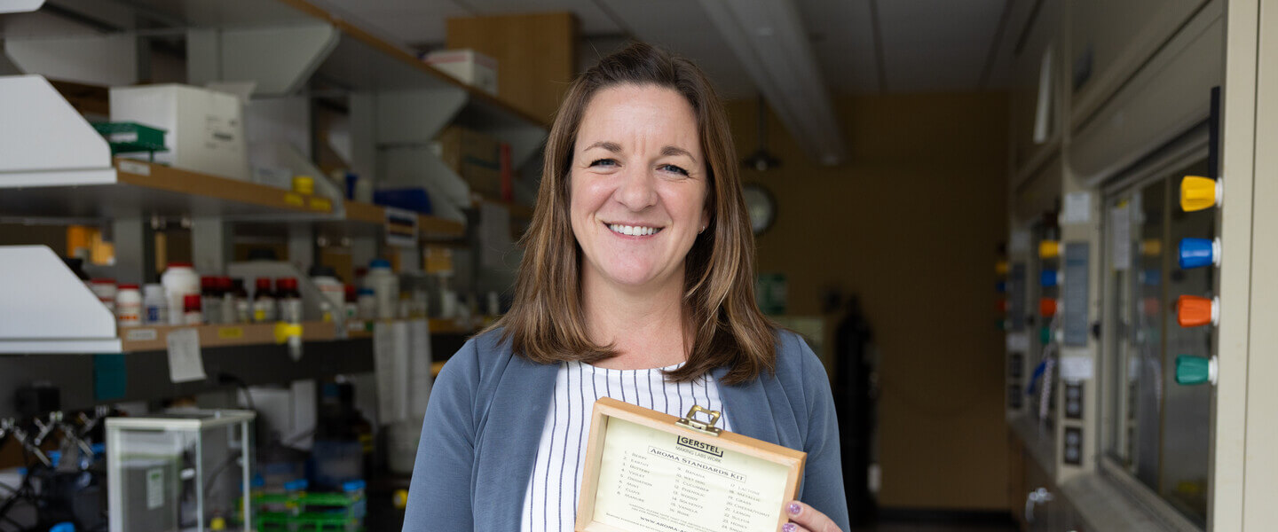 Woman holding a box containing tiny glass bottles