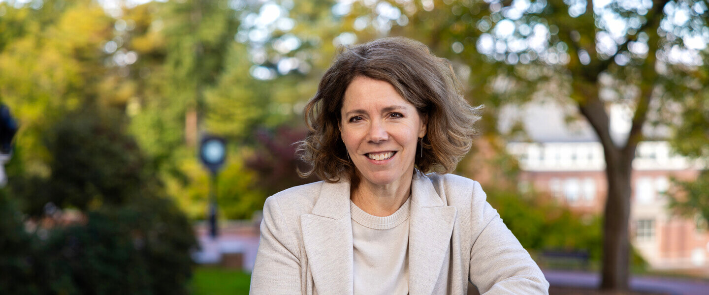 Woman leaning against wrought-iron railing