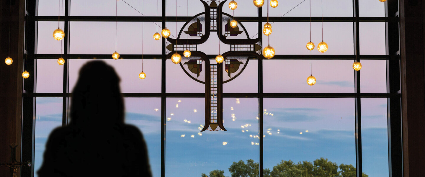 Silhouette of a person in front of the window at the Joyce Contemplative Center