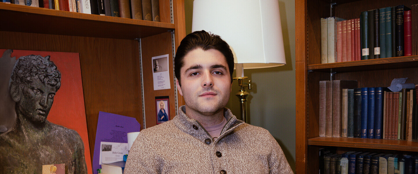 Young man with book at desk