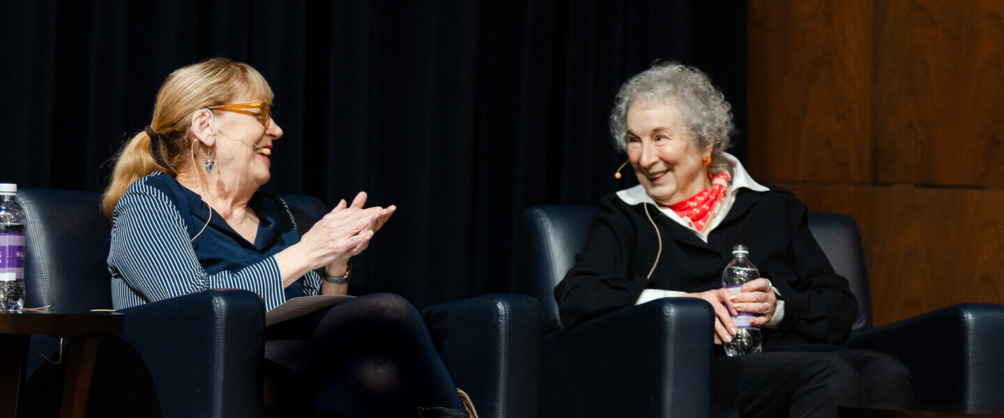 Two women sit in chairs talking