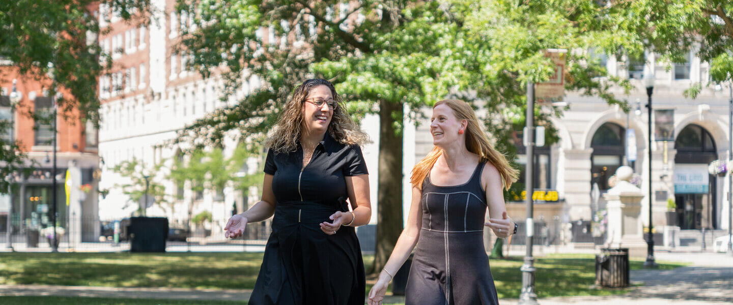 Two women walking in the Worcester Common